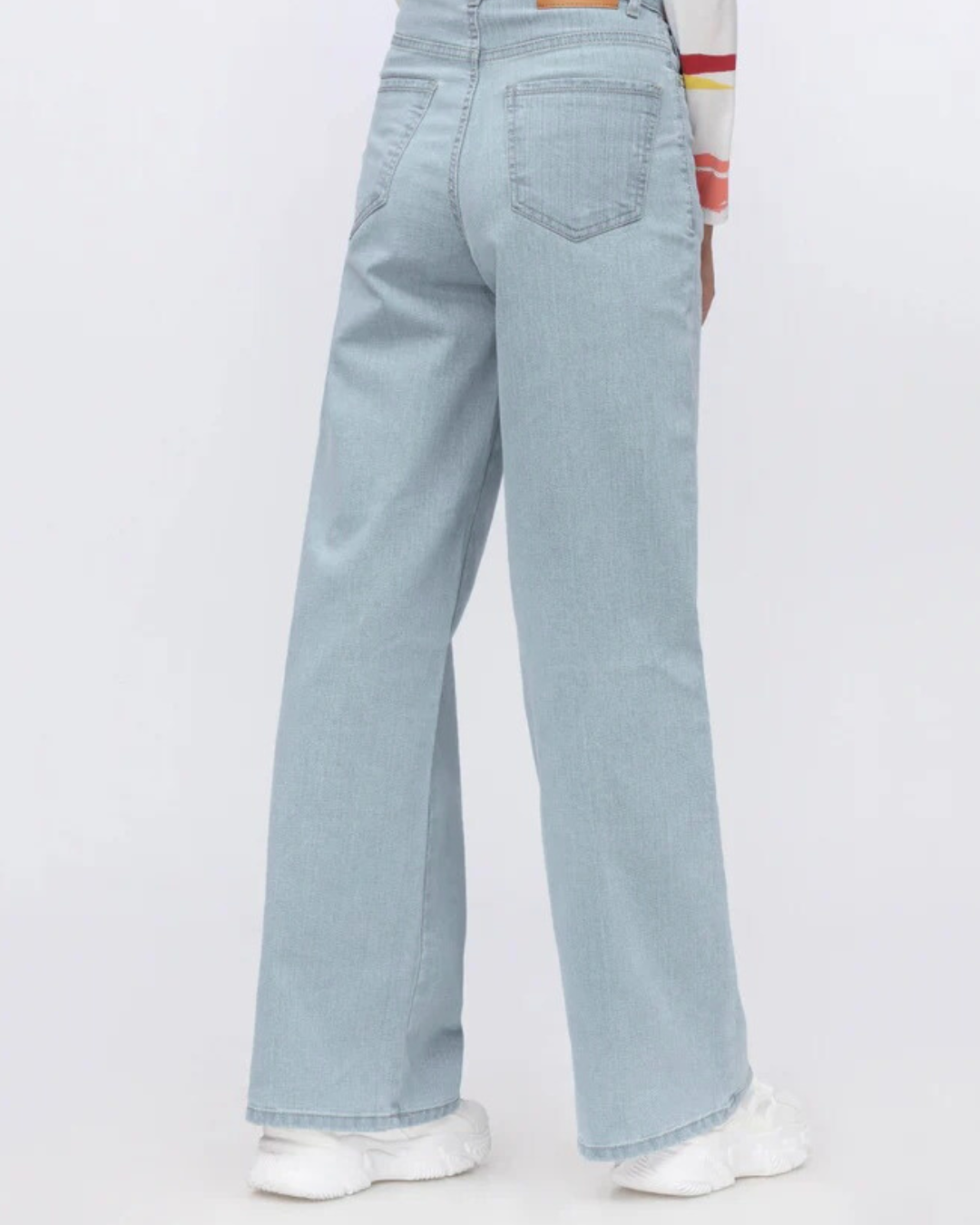 Light blue jeans worn by a person on a white background