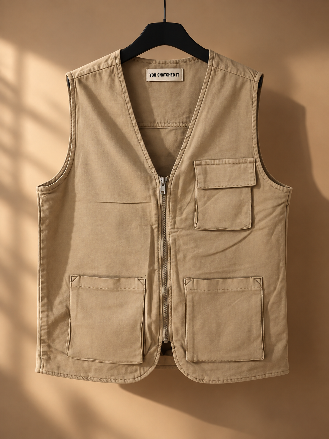 REBEL beige utility vest styled with white wide-leg jeans - front view