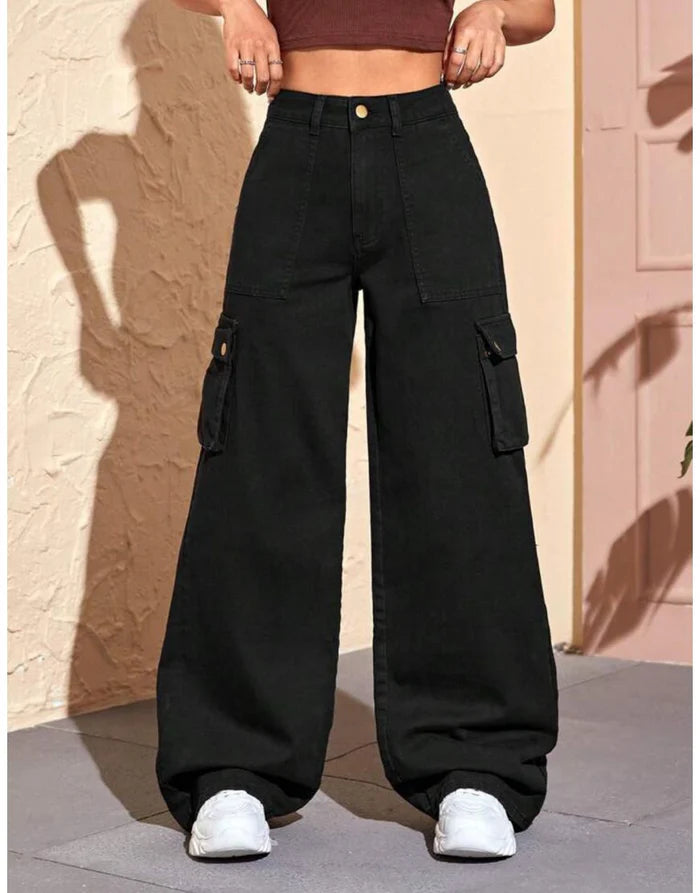 Person wearing black baggy cargo pants with a neutral background