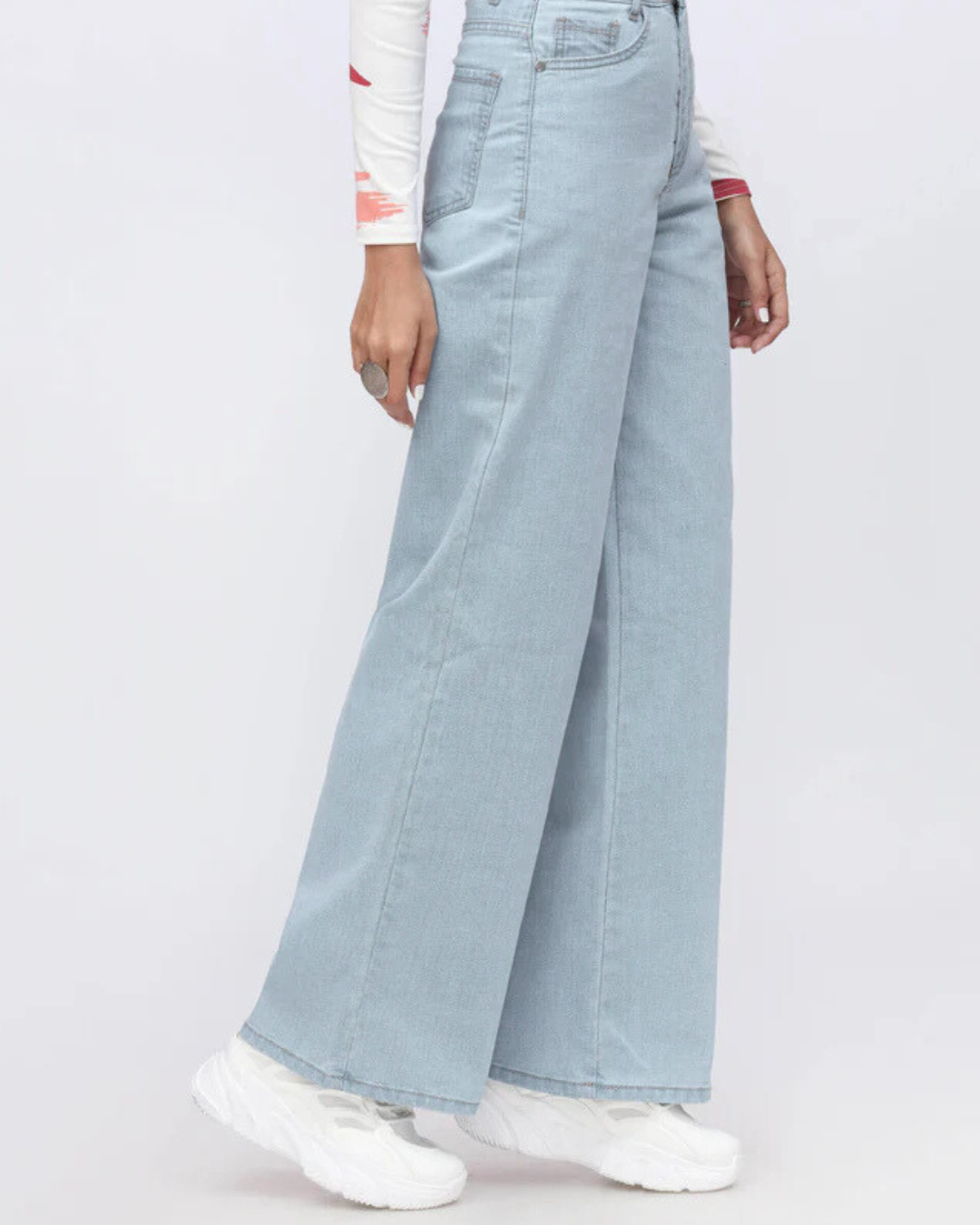 Light blue wide-leg jeans worn by a person on a white background