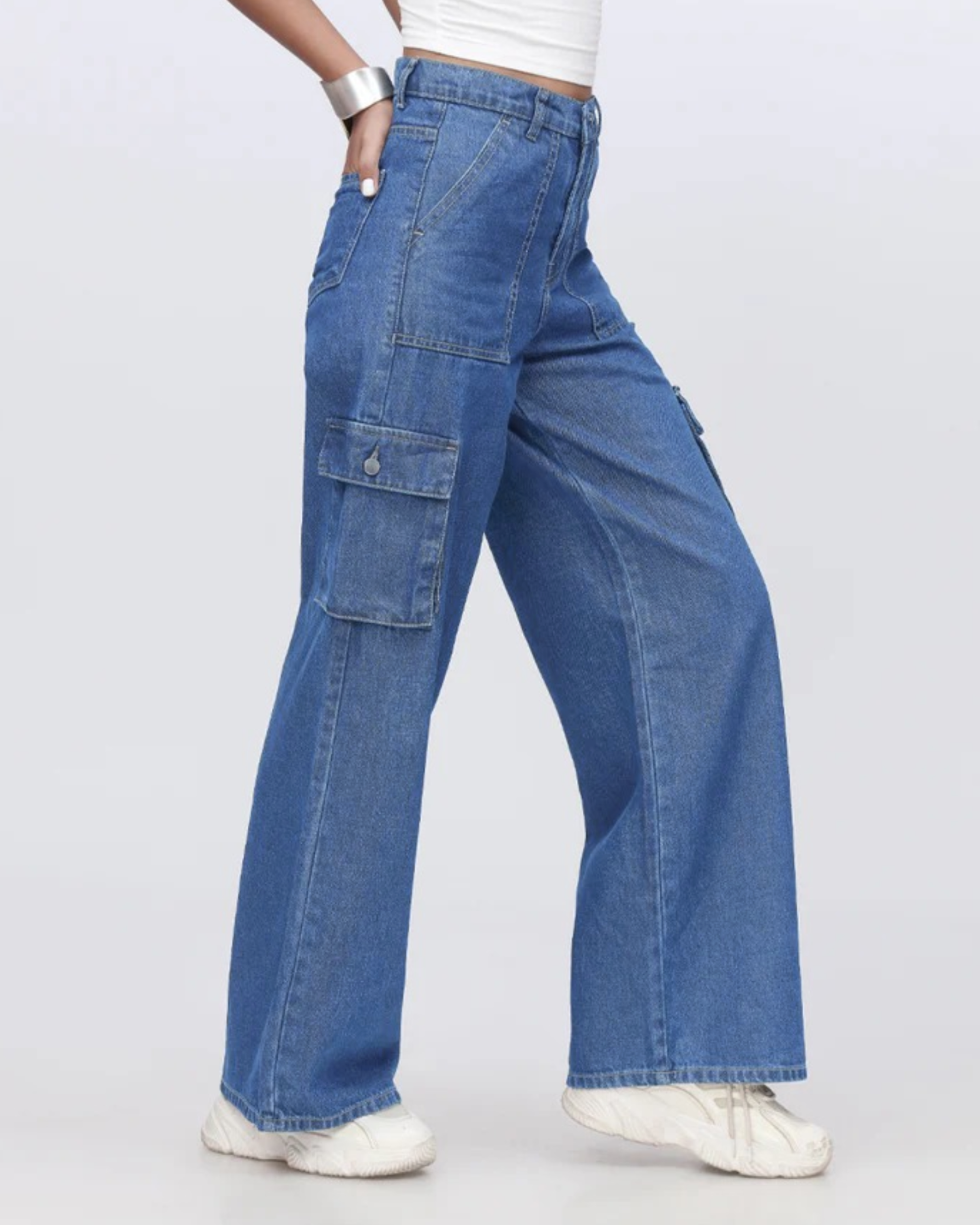 Blue wide-leg cargo jeans worn by a person on a white background