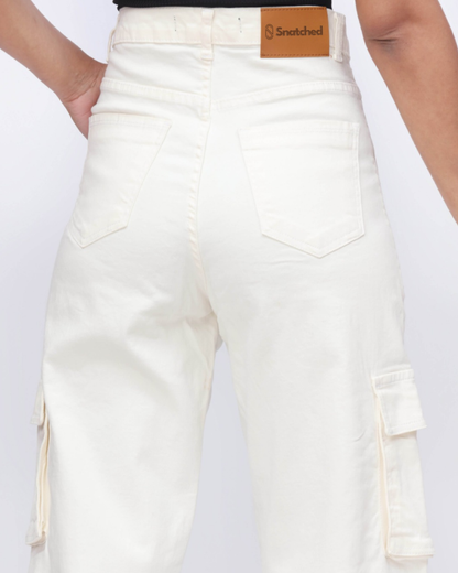 White cargo pants with a brand label on a white background